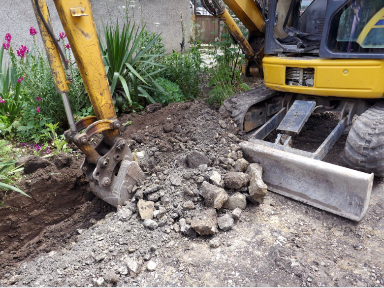Digger excavating a trench on a construction site