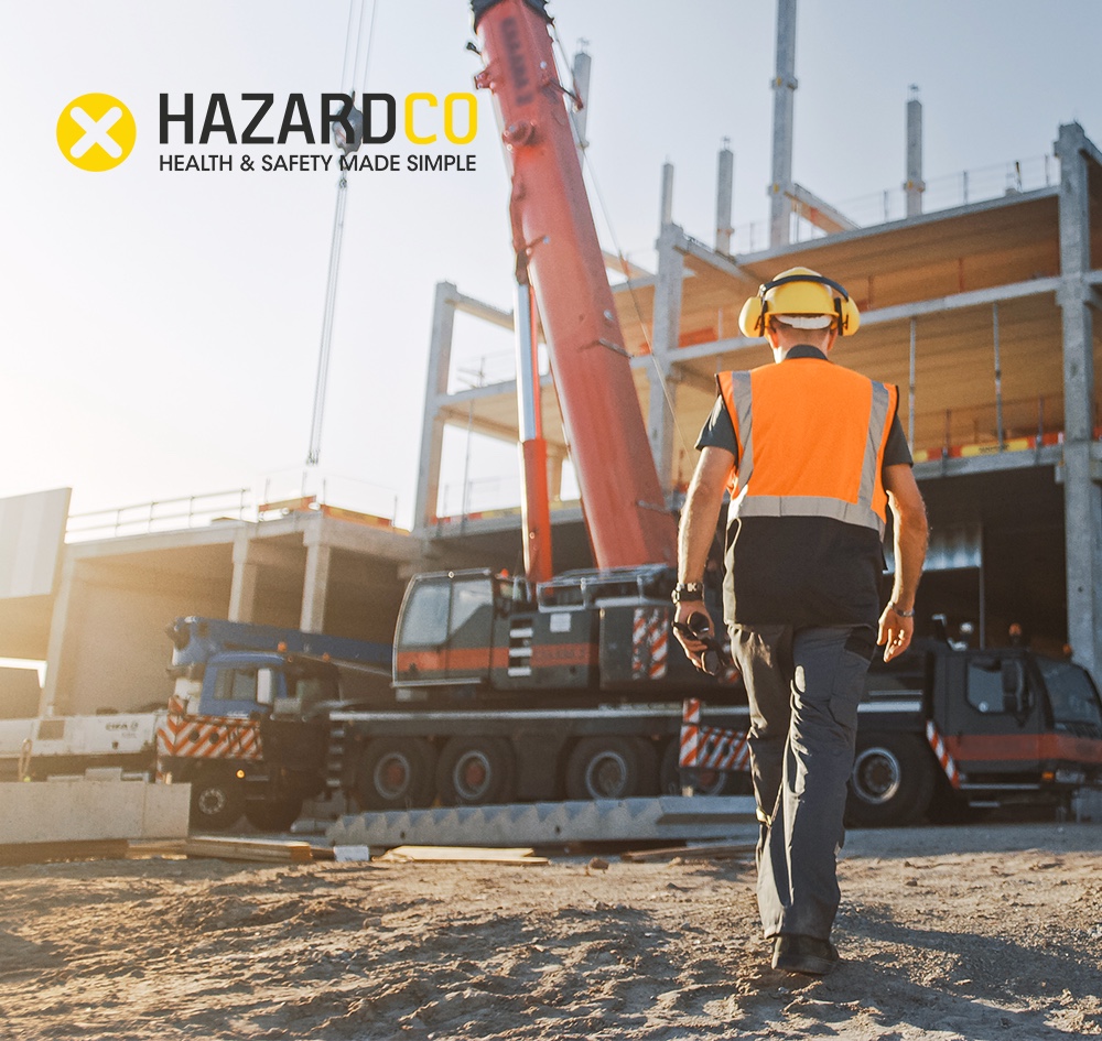 Construction worker walking towards a crane