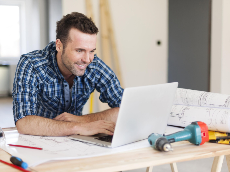 tradie usign computer on construction site
