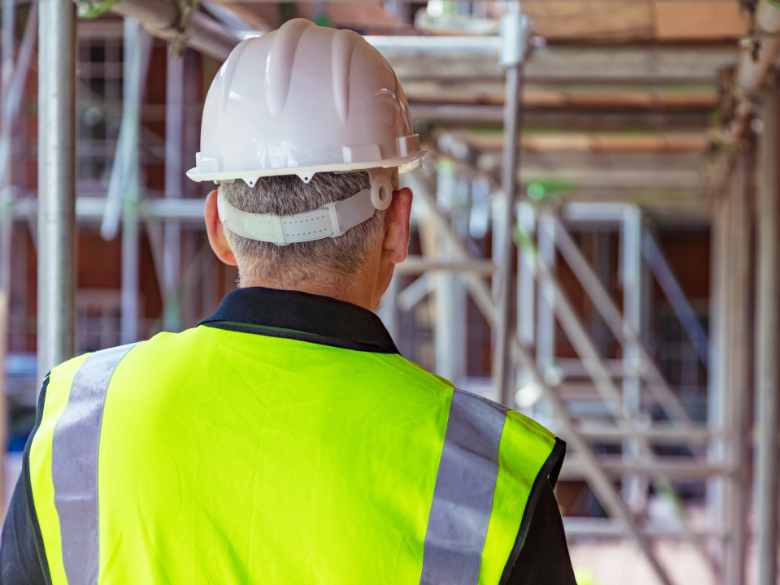 Worker on construction site with hard hat on