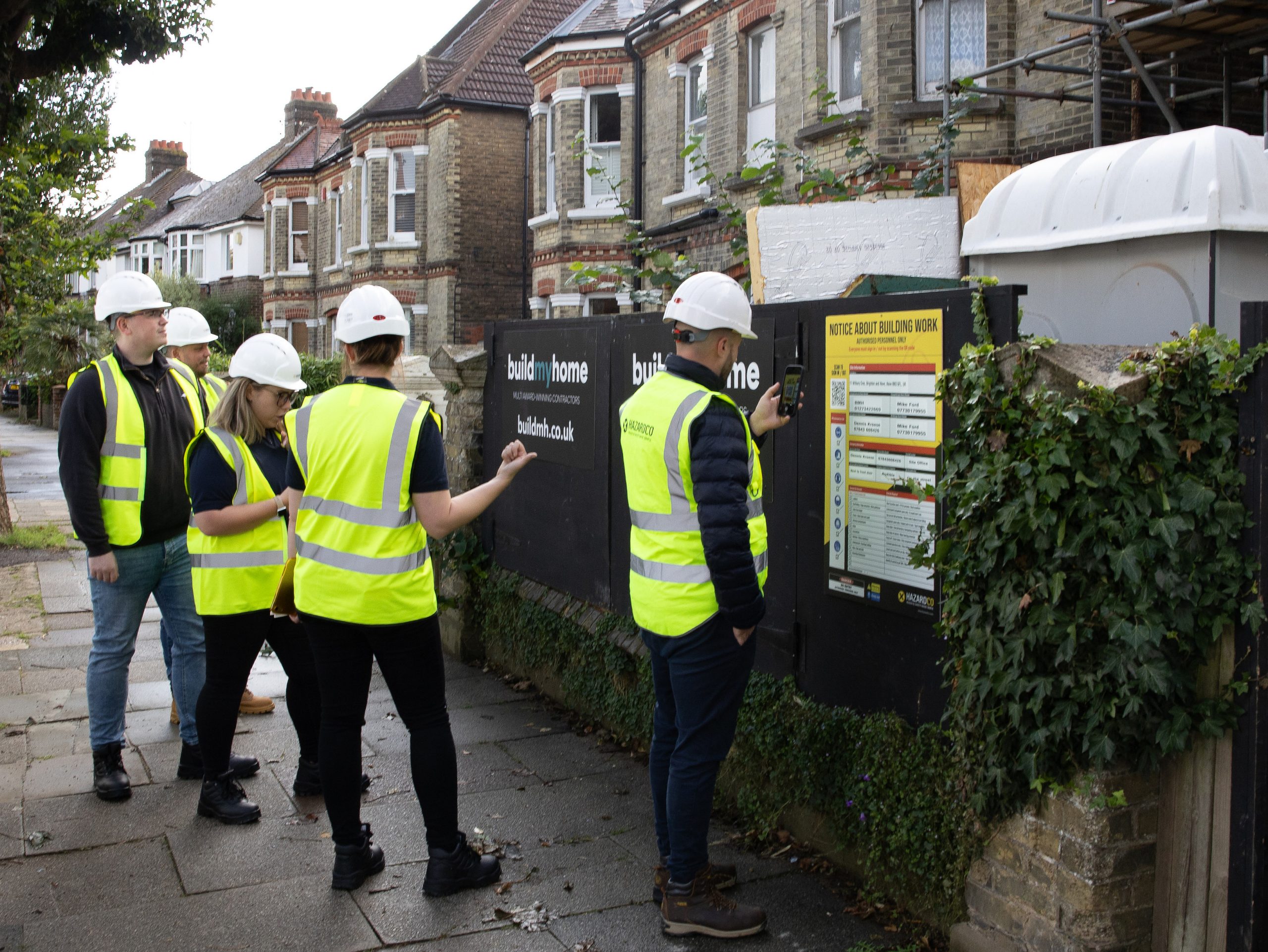 Team of construction workers scanning into a site using HazardCo