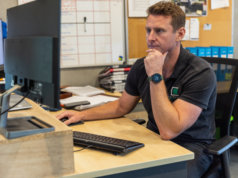 Construction business owner doing work on his computer in his office